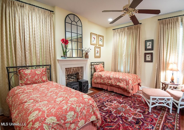 bedroom with a fireplace, recessed lighting, and wood finished floors