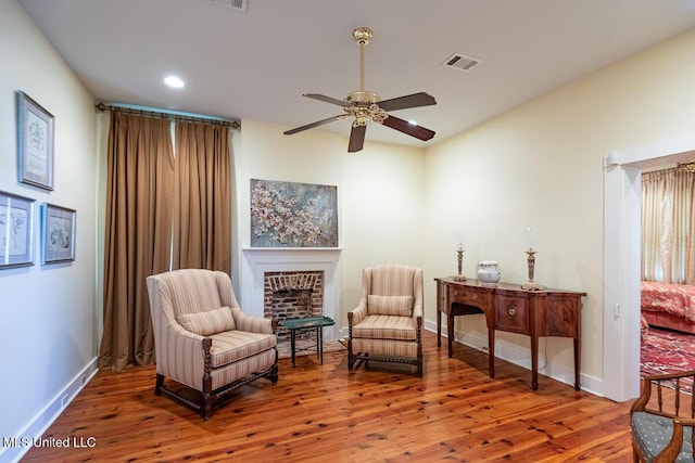 sitting room with visible vents, wood finished floors, baseboards, recessed lighting, and a ceiling fan