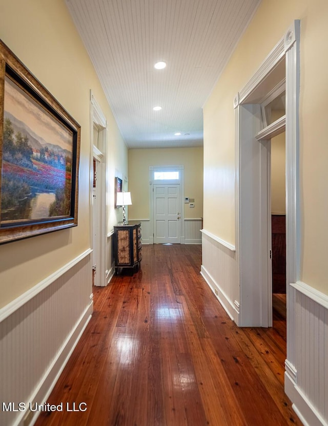 hall with wood-type flooring, wainscoting, and recessed lighting