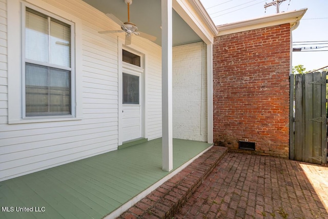 view of patio featuring fence, a gate, and ceiling fan