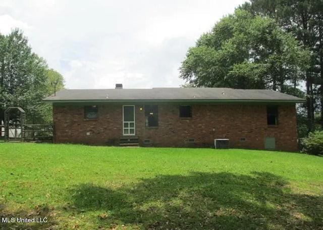 rear view of house with a yard