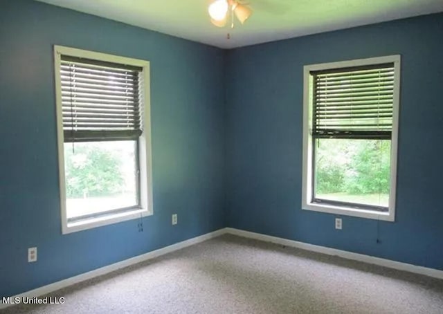 spare room featuring a healthy amount of sunlight and ceiling fan