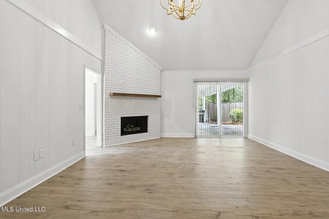 132 Bent Creek Dr, Brandon, MS 39047 - unfurnished living room with wood finished floors, a chandelier, a fireplace, and high vaulted ceiling