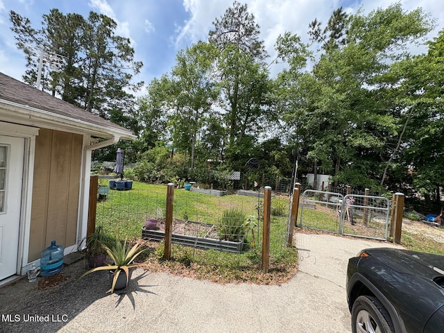 710 Beyer Dr, Bay Saint Louis, MS 39520 - view of yard with a gate, fence, and a vegetable garden