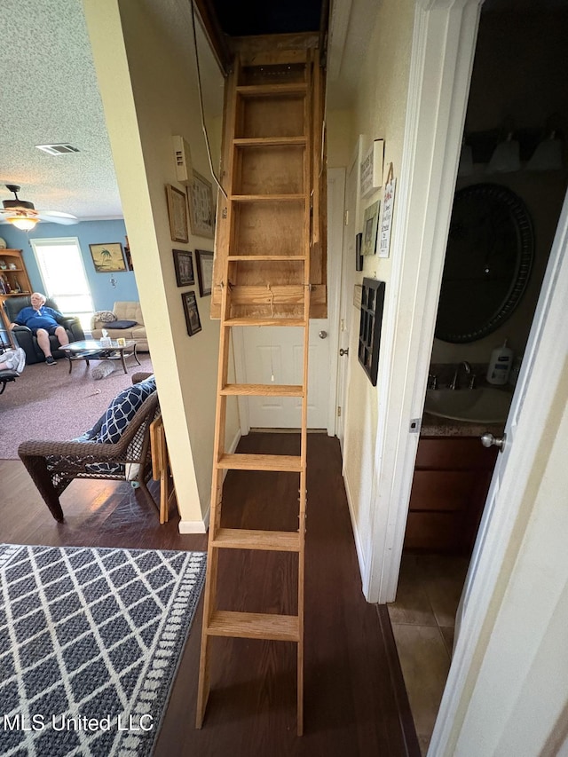 710 Beyer Dr, Bay Saint Louis, MS 39520 - stairs featuring ceiling fan, visible vents, a textured ceiling, and wood finished floors