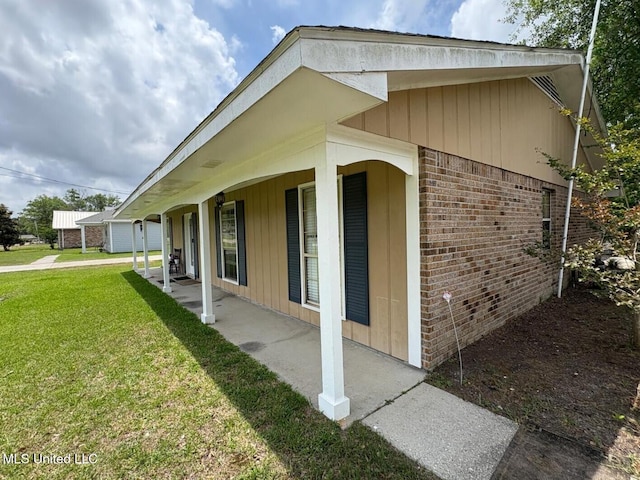 710 Beyer Dr, Bay Saint Louis, MS 39520 - view of side of property featuring brick siding and a yard