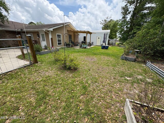 710 Beyer Dr, Bay Saint Louis, MS 39520 - view of yard featuring a patio area, fence, and a garden