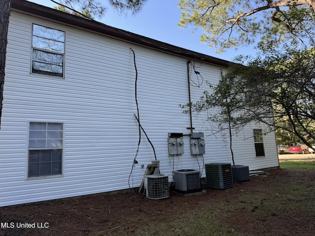 view of side of property with central air condition unit