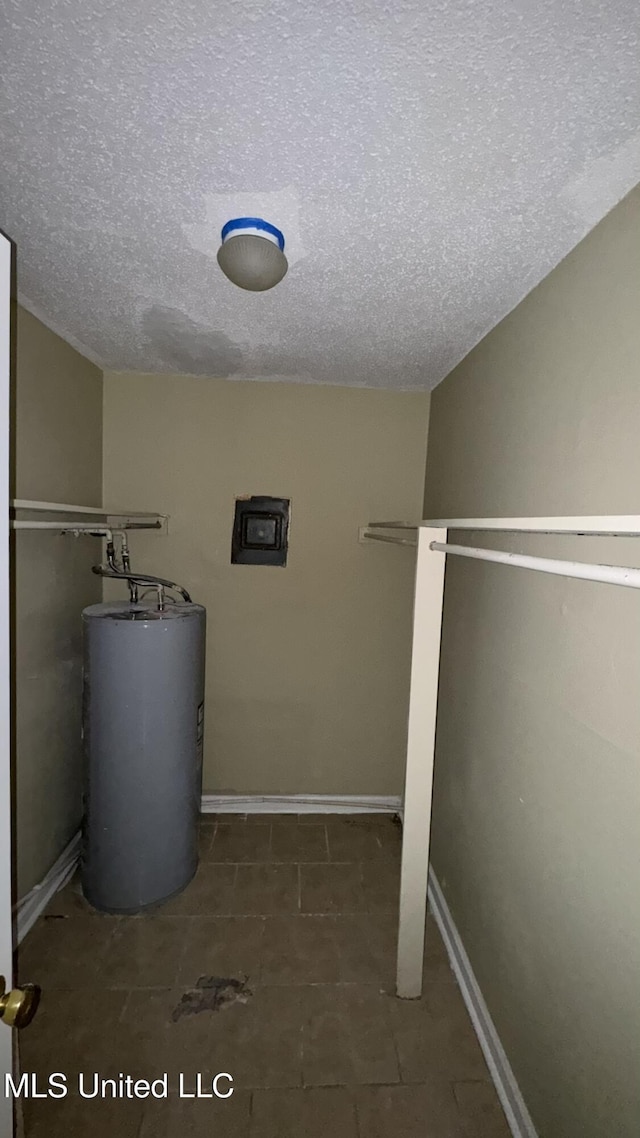 utility room featuring water heater