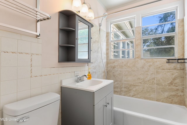 full bathroom with vanity, bathing tub / shower combination, toilet, and tile walls