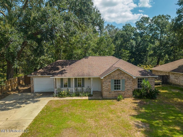 ranch-style home featuring a garage, covered porch, and a front lawn