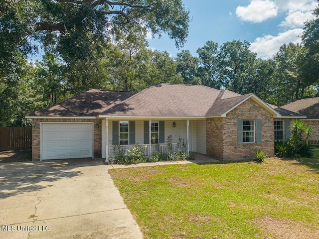 ranch-style home with a garage, covered porch, and a front yard