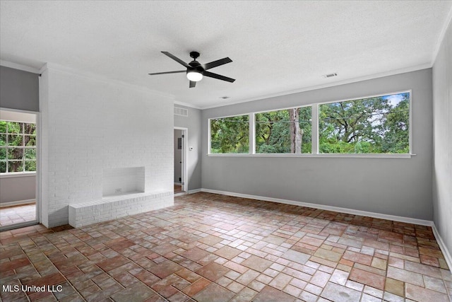 unfurnished room with ornamental molding, a brick fireplace, and a healthy amount of sunlight