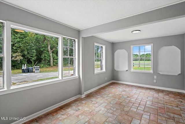 spare room with a healthy amount of sunlight and a textured ceiling