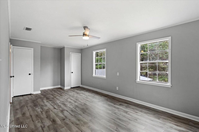 unfurnished room with hardwood / wood-style flooring, ceiling fan, and ornamental molding