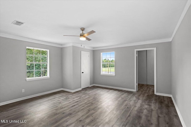 spare room with dark hardwood / wood-style floors, ceiling fan, and crown molding