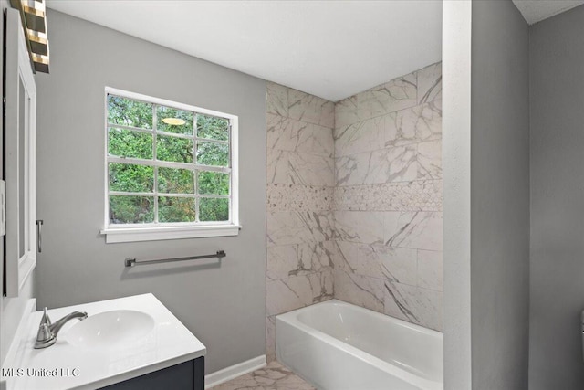 bathroom featuring vanity and tiled shower / bath