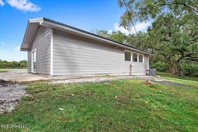 view of home's exterior featuring a lawn and central air condition unit