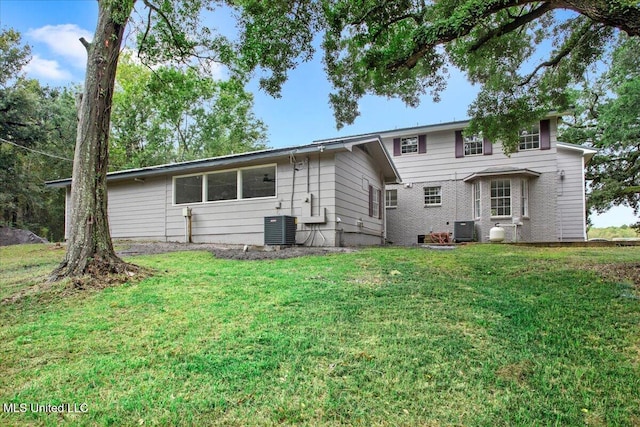 back of property with a yard and cooling unit