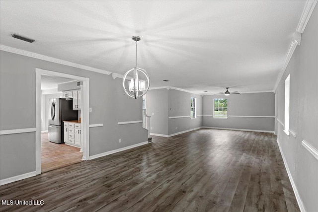 unfurnished living room featuring a textured ceiling, ceiling fan with notable chandelier, dark hardwood / wood-style floors, and ornamental molding