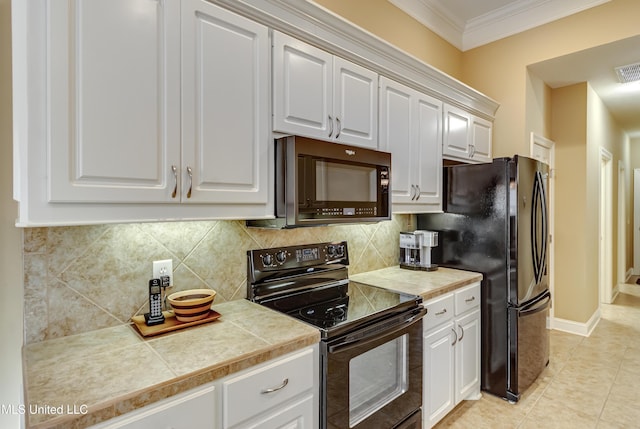 kitchen featuring black appliances, tasteful backsplash, white cabinetry, and crown molding