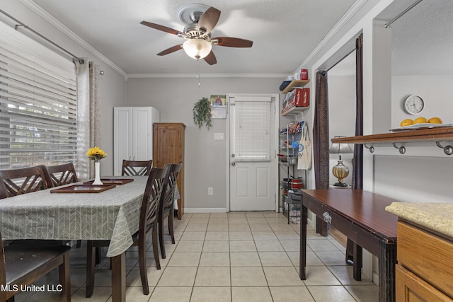 dining room featuring crown molding, light tile patterned flooring, a textured ceiling, and ceiling fan