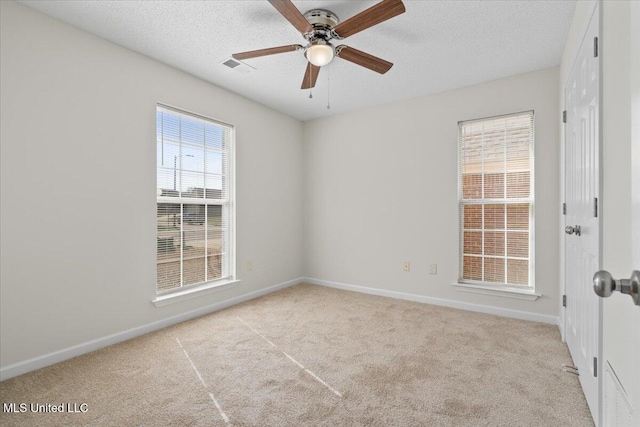 unfurnished room featuring baseboards, a textured ceiling, ceiling fan, and carpet floors