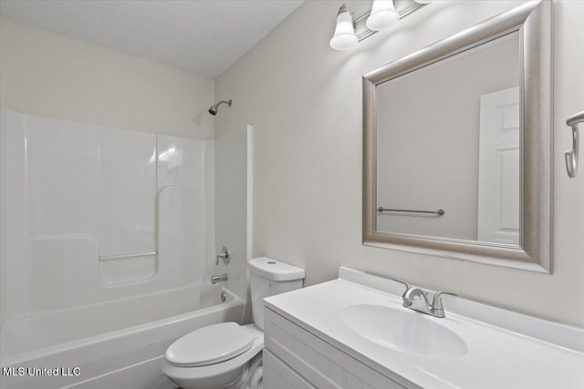 full bath featuring shower / washtub combination, a textured ceiling, toilet, and vanity