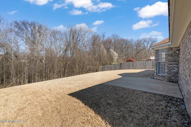 view of yard featuring a patio area and fence