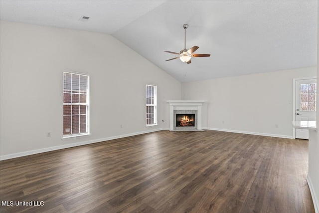 unfurnished living room featuring a fireplace, dark wood-style floors, baseboards, and ceiling fan