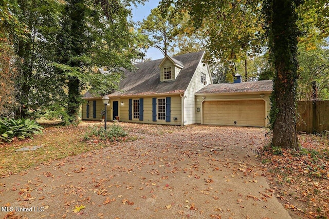 cape cod-style house featuring a garage