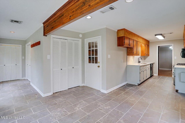 kitchen featuring beam ceiling, black appliances, and sink