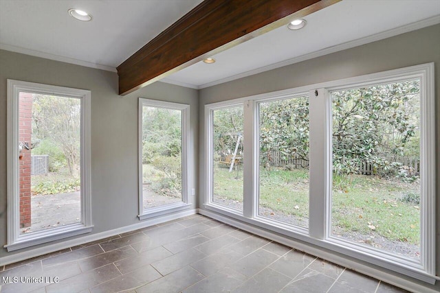 unfurnished sunroom featuring a wealth of natural light and beamed ceiling