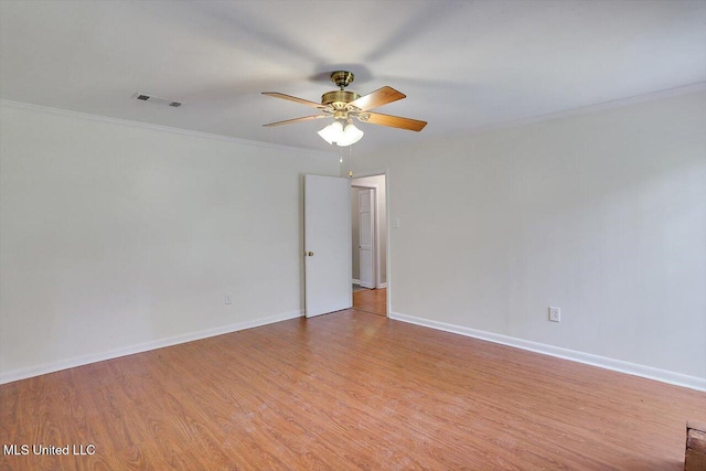 empty room with crown molding, light wood-type flooring, and ceiling fan