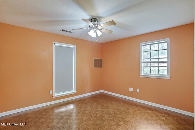 spare room with light parquet floors and ceiling fan