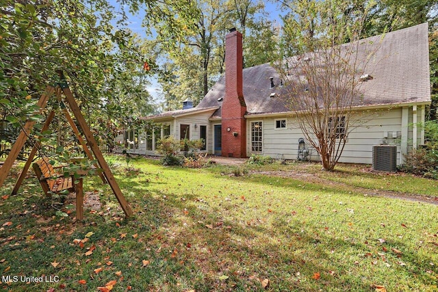 back of property featuring a yard and central AC unit