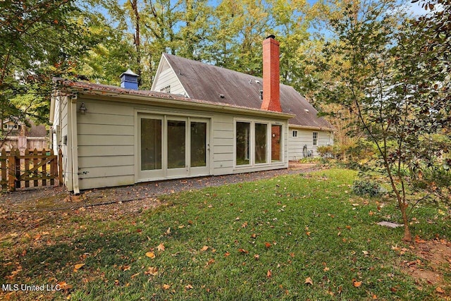 rear view of property featuring a yard