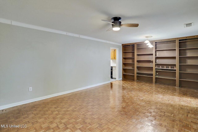 unfurnished living room with parquet flooring, ornamental molding, and ceiling fan