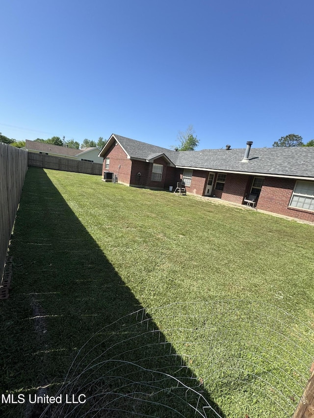 view of yard with a fenced backyard