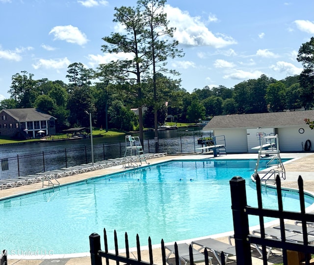106 Donnybrook Dr, Carriere, MS 39426 - community pool featuring fence, a water view, a patio, and view of wooded area