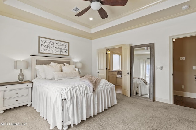 bedroom with visible vents, light carpet, ornamental molding, baseboards, and a raised ceiling