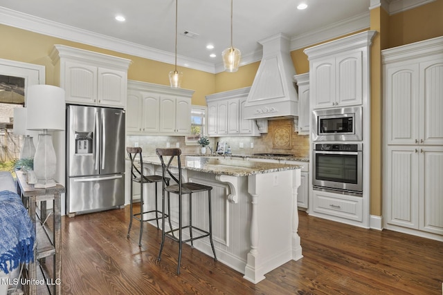 kitchen featuring dark wood-style floors, light stone countertops, stainless steel appliances, custom range hood, and a kitchen breakfast bar