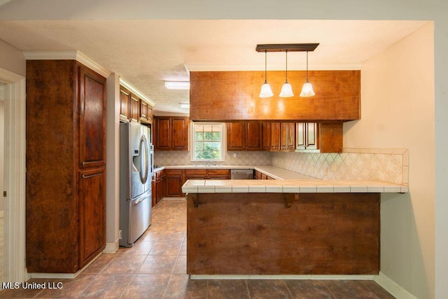 290 Abigail Ln, Bentonia, MS 39040 - kitchen featuring tile counters, a sink, decorative backsplash, stainless steel appliances, and a peninsula