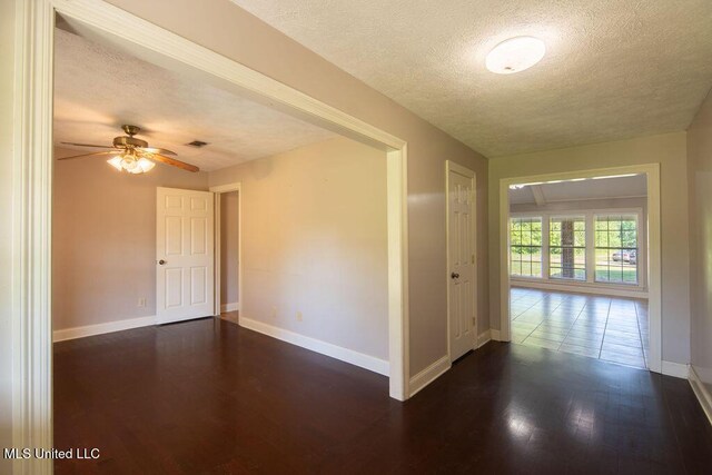 290 Abigail Ln, Bentonia, MS 39040 - empty room featuring visible vents, baseboards, a textured ceiling, and dark wood-style floors