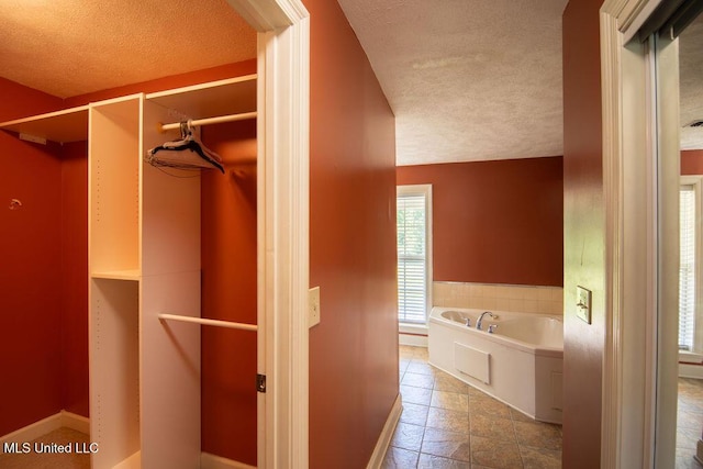 290 Abigail Ln, Bentonia, MS 39040 - bathroom with a bath, a textured ceiling, and baseboards