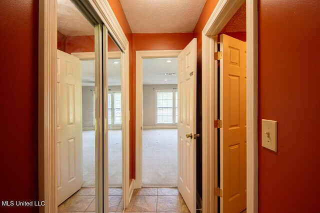 290 Abigail Ln, Bentonia, MS 39040 - hall featuring light carpet, a textured ceiling, and light tile patterned floors