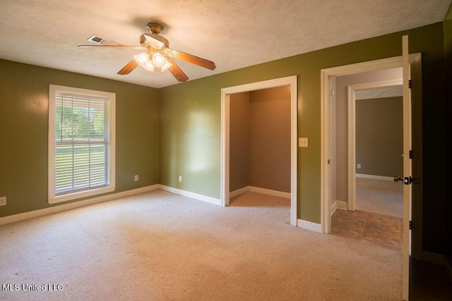290 Abigail Ln, Bentonia, MS 39040 - unfurnished bedroom featuring a textured ceiling, baseboards, and light carpet