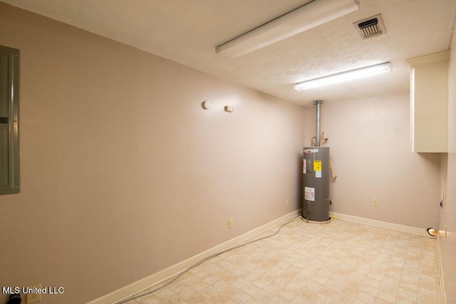 290 Abigail Ln, Bentonia, MS 39040 - finished below grade area with baseboards, electric water heater, visible vents, and a textured ceiling