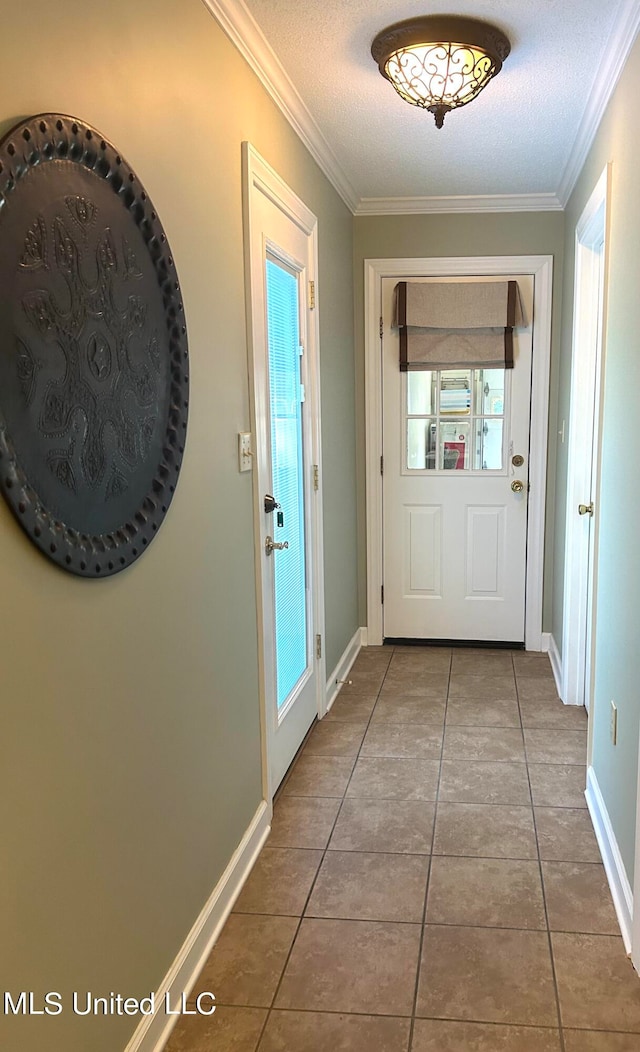 doorway to outside featuring tile patterned floors, crown molding, and a textured ceiling