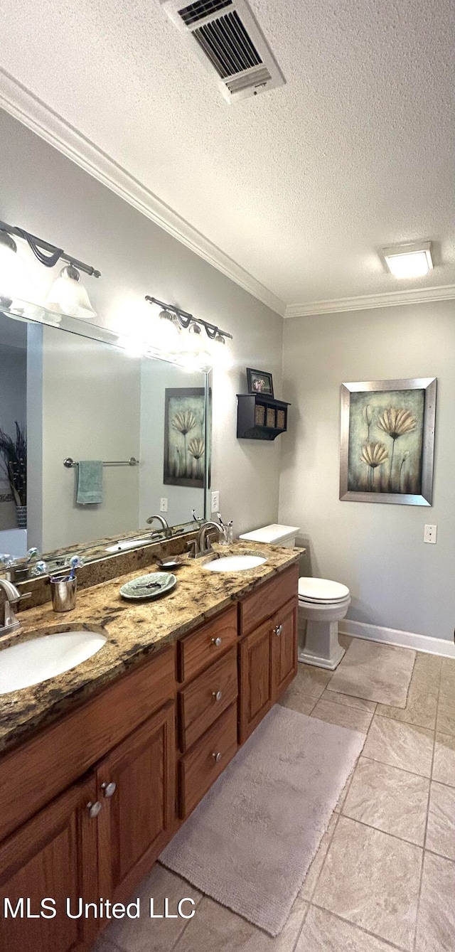 bathroom with vanity, crown molding, a textured ceiling, and toilet